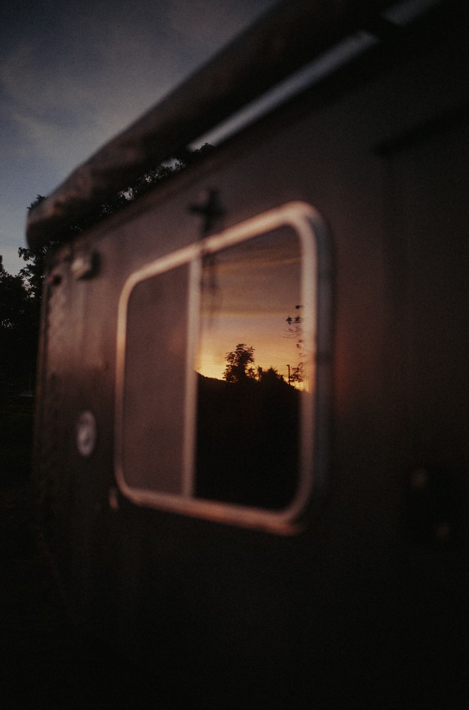 Sunset seen through the window of the Kia Bongo camper cabin