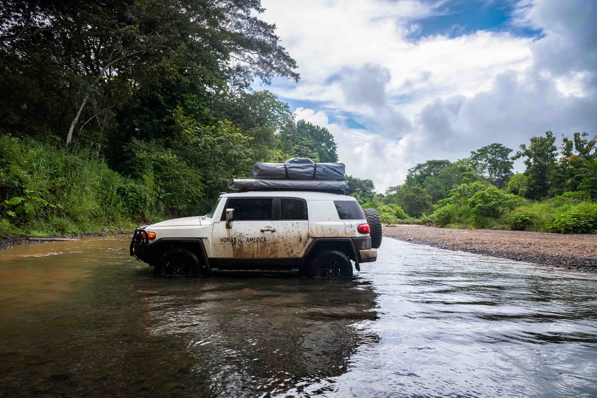Toyota FJ Cruiser driving through a flooded track
