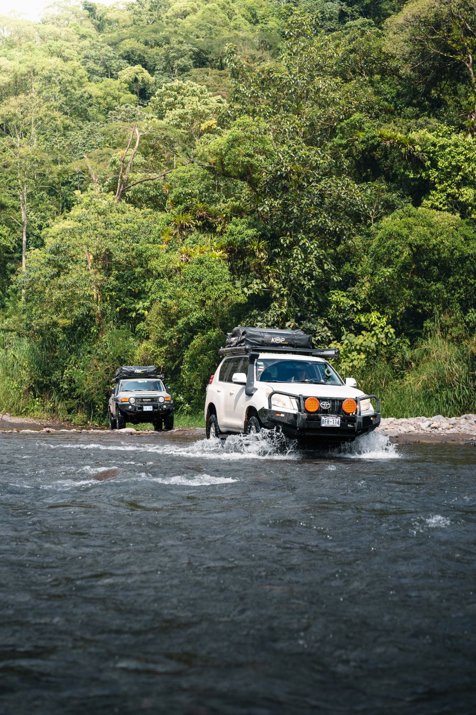 Toyota Fortuner driving through a shallow river