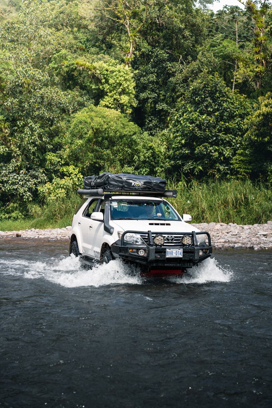 Toyota Fortuner splashing through a river crossing