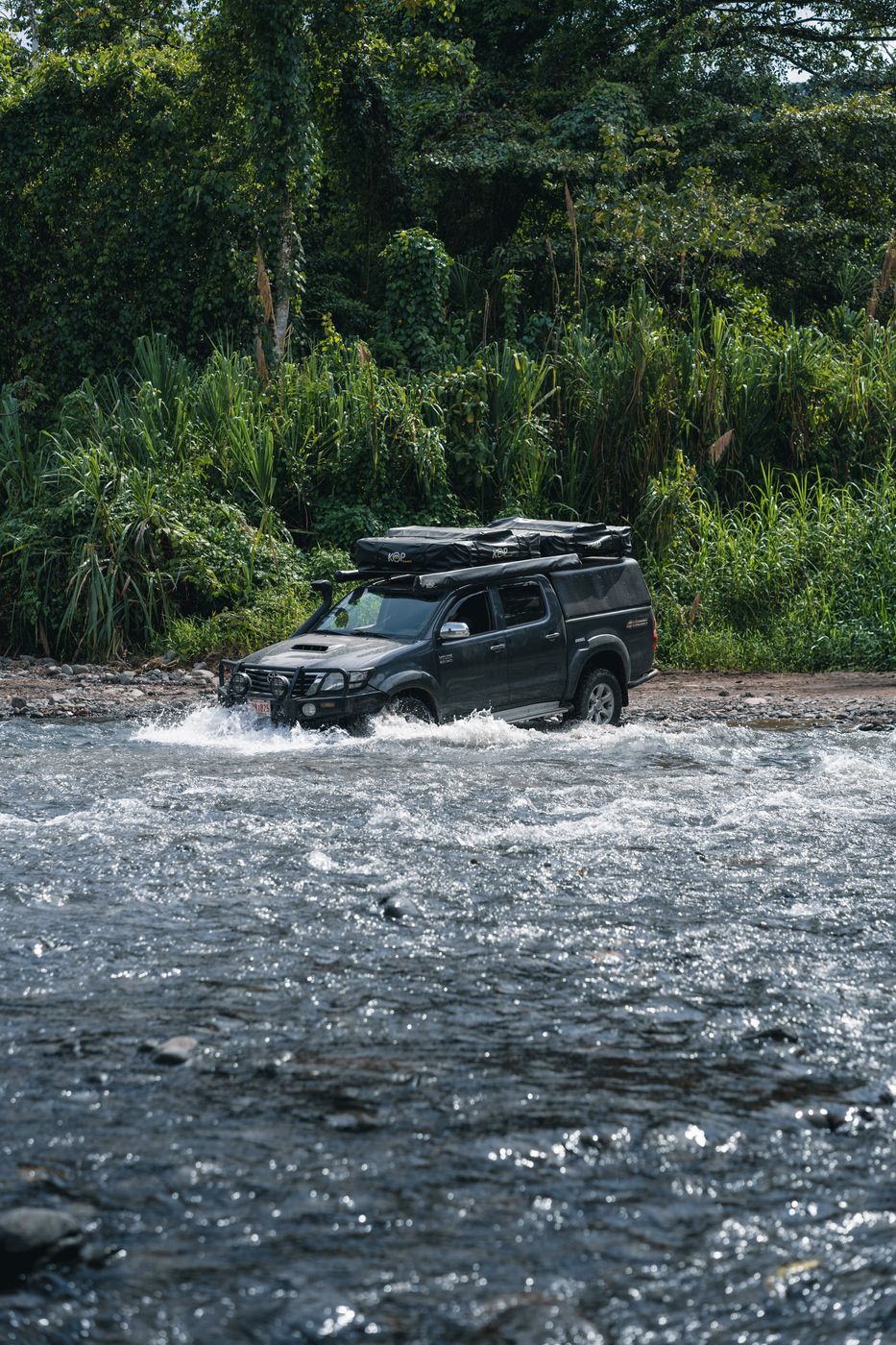 Toyota Hilux crossing a wide river