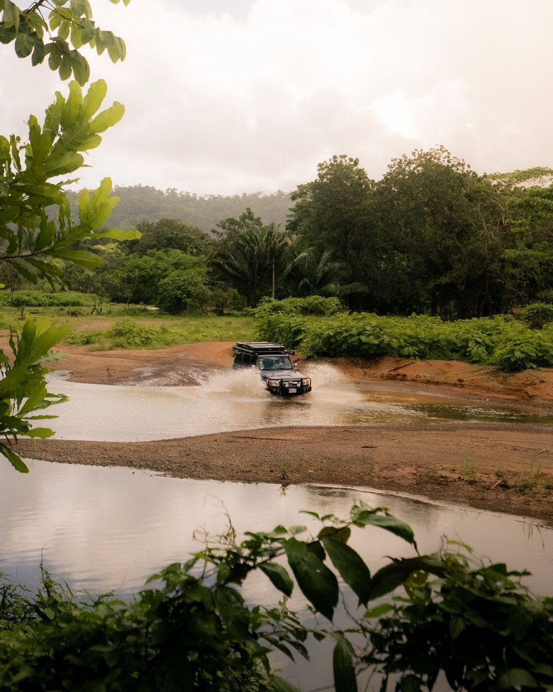 Toyota Land Cruiser LX crossing a shallow river