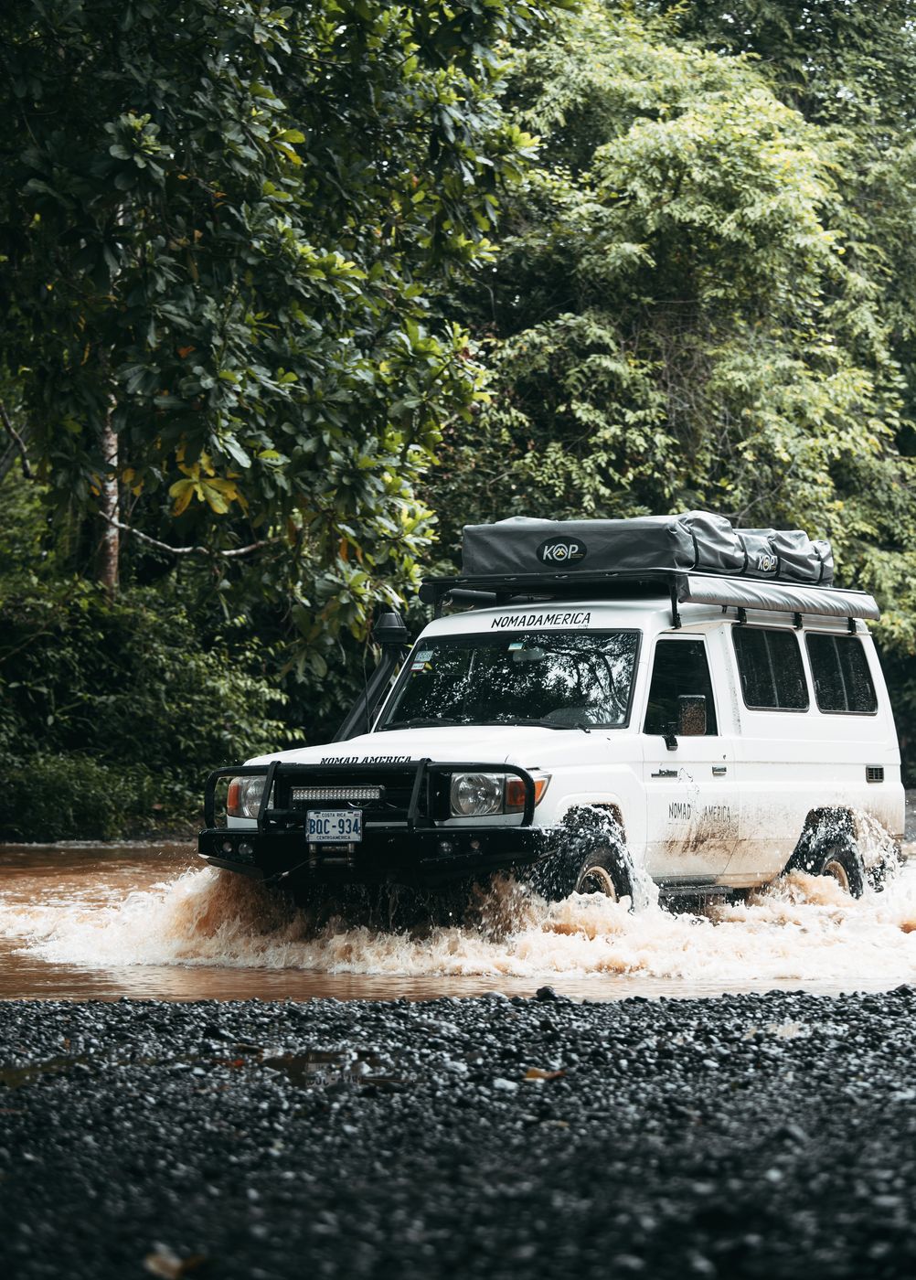 Toyota Land Cruiser Troopie splashing through a river crossing